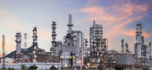 Oil and gas industrial refinery at twilight, Oil refinery and Petrochemical plant pipeline steel, Refinery factory oil storage tank and pipeline steel at night.