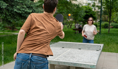 Table tennis in park. Ping pong summer sport outside, people play pingpong, table tennis game