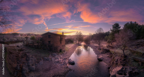 Rustic Stone House by River in Mountain Countryside