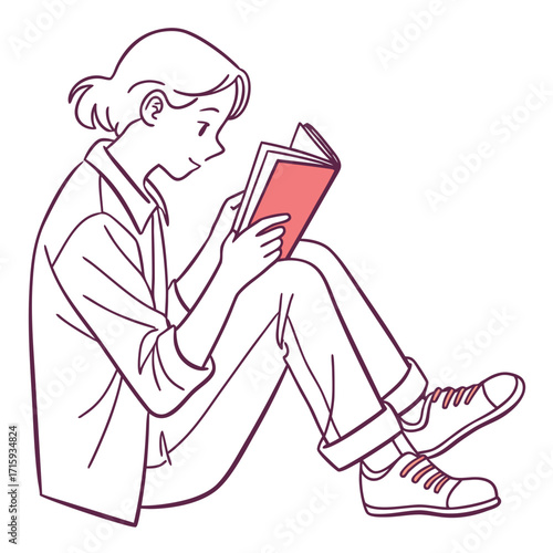 A young person sitting cross legged on the floor engrossed in reading a book