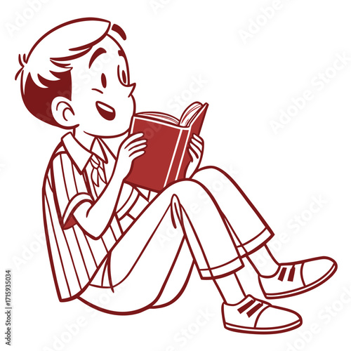 Happy young boy sitting cross legged reading an open book with a smile on his face