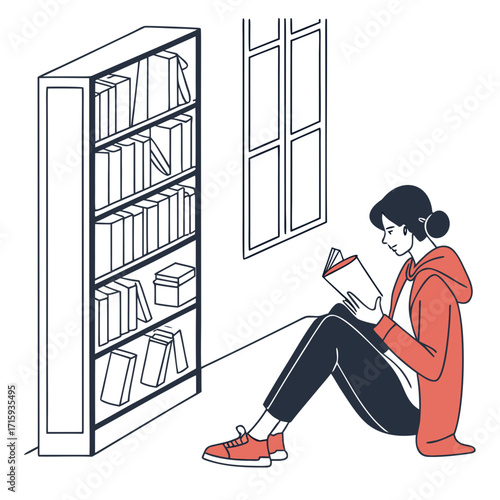 Young woman in casual clothing sitting on the floor reading a book next to a bookshelf and window