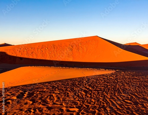Sunrise over red desert dunes