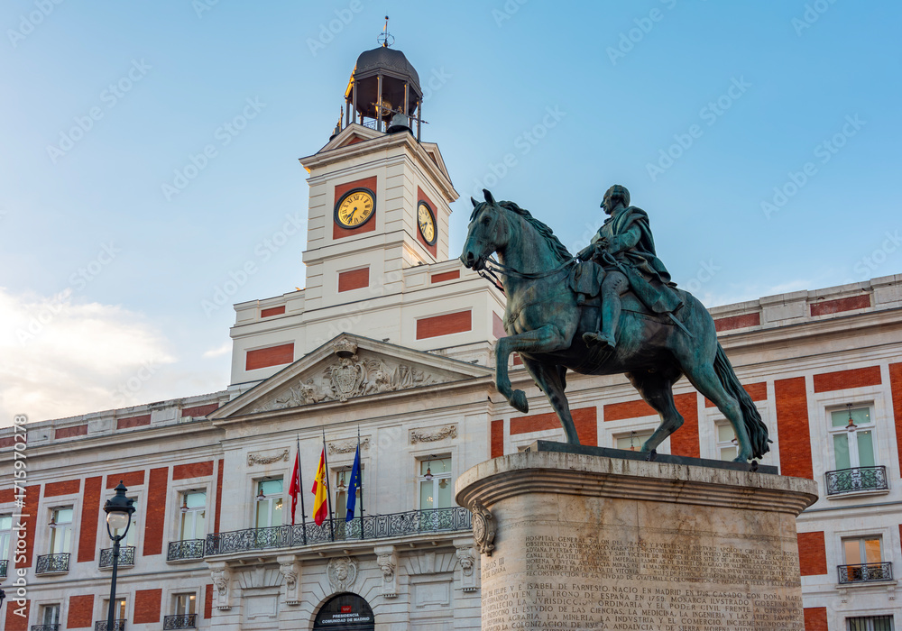 Fototapeta premium Post office building and statue of king Charles III on Puerta del Sol square, Madrid, Spain
