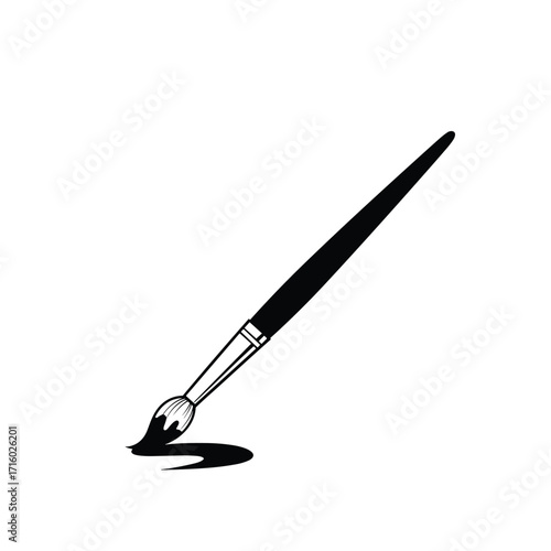 A paintbrush dipped in dark ink creating a stroke of art.