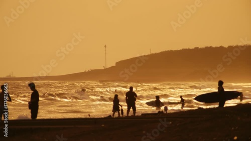 Japan Golden Hour Surfers – Sunset silhouettes moving through glowing waves in Shonan.