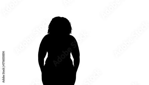 Confident woman with curly hair stands with hands in pockets, projecting self-assurance and modern style in a clean, minimalist silhouette that is perfect for diverse commercial applications.