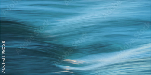 Aqua liquid ripples create an abstract, textured pattern on the surface of the blue ocean.