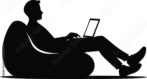 Silhouette of a man sitting in a beanbag chair using a laptop person