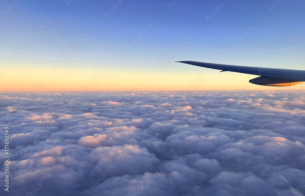 Obraz premium A view from a airplane window at beautiful sunset sky with clouds