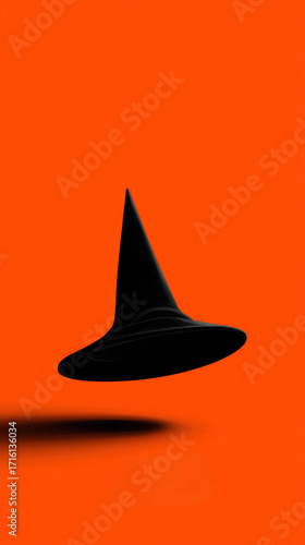 Black witch hat floating, minimalist style, bright orange background, Halloween theme, mysterious and playful mood
