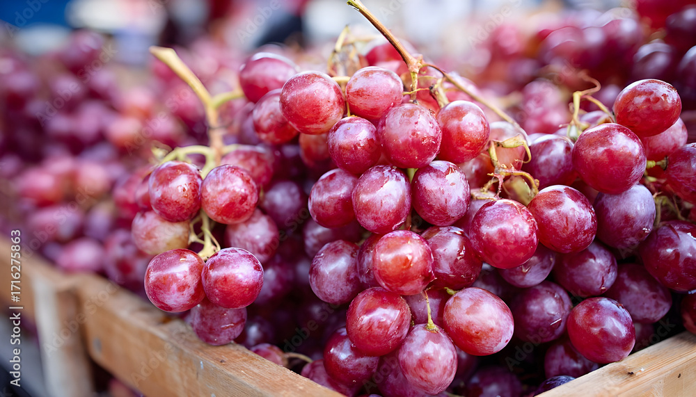 Obraz premium Ripe grapes for sale in the outdoor farm market. Red grapes on wooden background