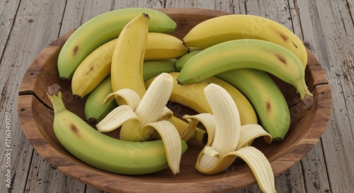 Vibrant Yellow and Green Bananas, Some Peeled, in a Rustic Wooden Bowl.