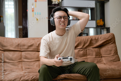 Картината върху платно young man with headset stressful while play games with controller