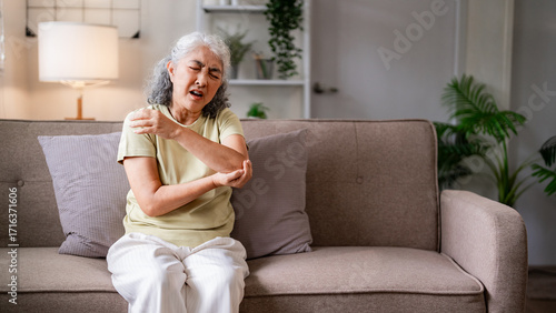 Canvas Print Asian senior woman elbow shoulder pain medical condition discomfort home living
