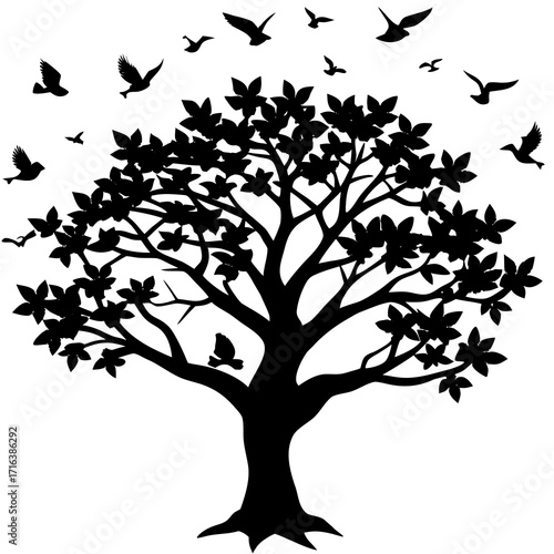 Black silhouette of a tree with leaves and flying birds