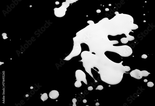 Blots from milk on black background