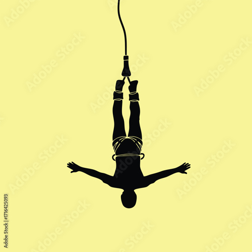 Silhouette of a person performing a bungee jump with arms outstretched against a plain yellow background