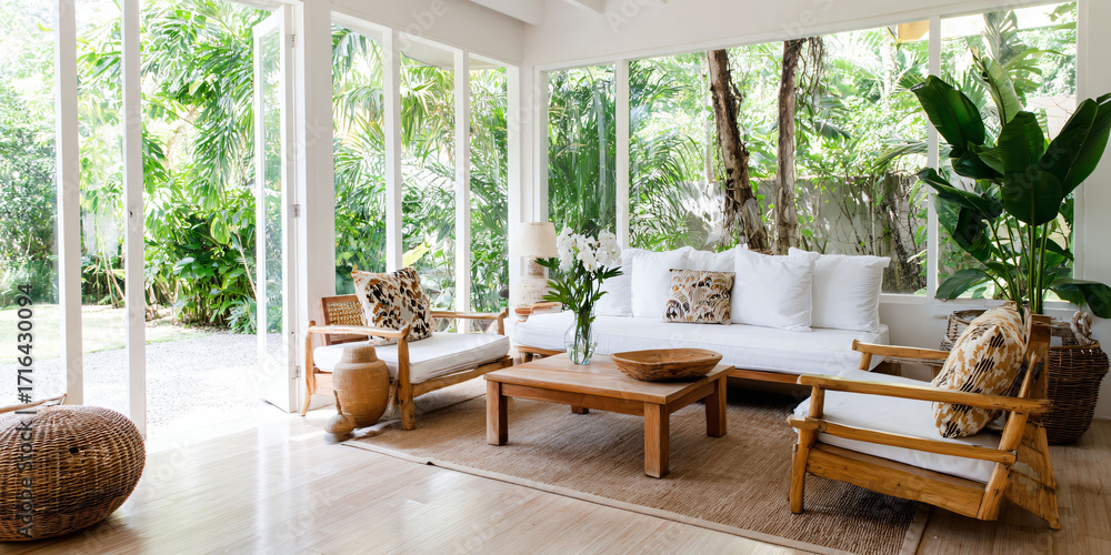 Fototapeta premium Tropical living room with lush greenery