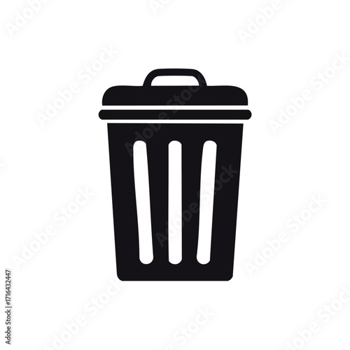 A simple black and white illustration of a trash bin with a lid and handle.