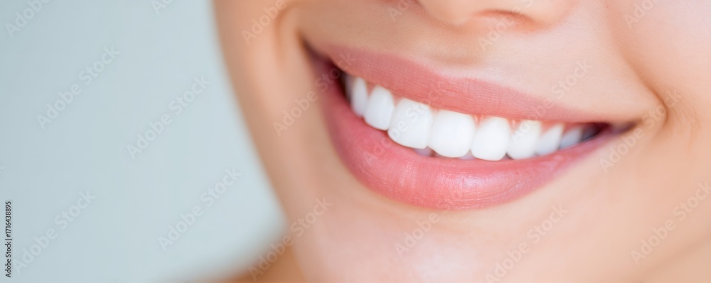 Fototapeta premium Close up of woman smiling with perfect white teeth. Dental health and oral hygiene concept for cosmetic dentistry. Modern orthodontic care.