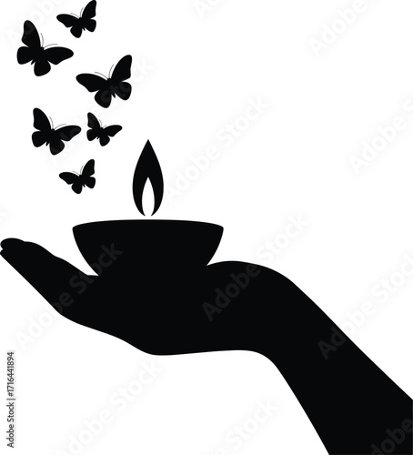 Silhouette of a hand holding a candle with butterflies emerging
