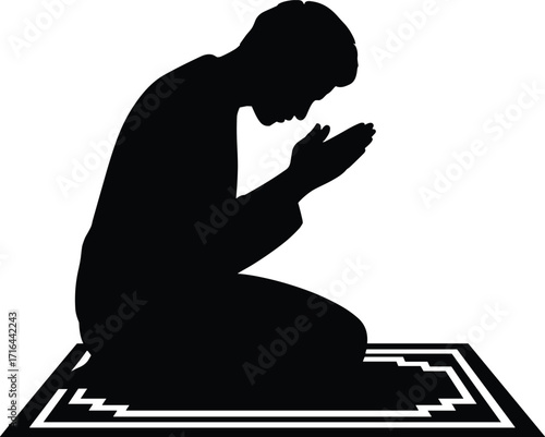 Silhouette of a person praying on a prayer mat