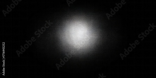A textured surface, highlighted in the center with a concentrated light source, creates a dramatic contrast.