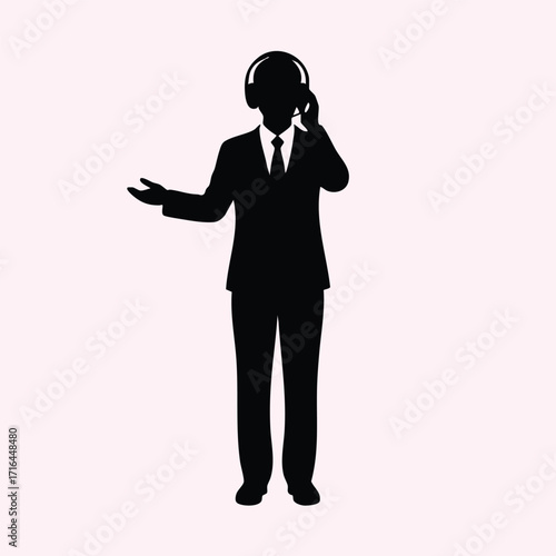 Silhouette of a professional person in a suit wearing headphones and gesturing with one hand on a light background