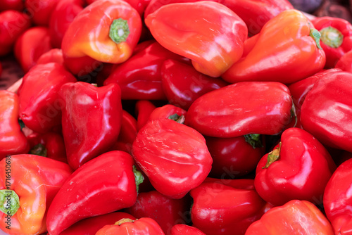 A heap of sweet red peppers. Close-up.