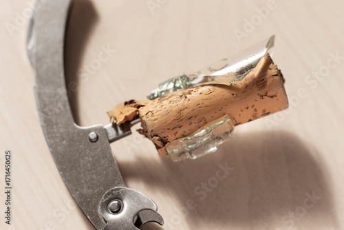Corkscrew and cork in a broken bottle neck. Close-up.