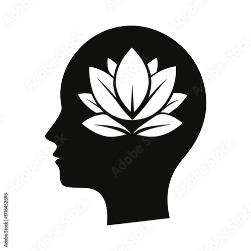 Silhouette of a human head with a blooming lotus flower symbolizing mindfulness and inner peace