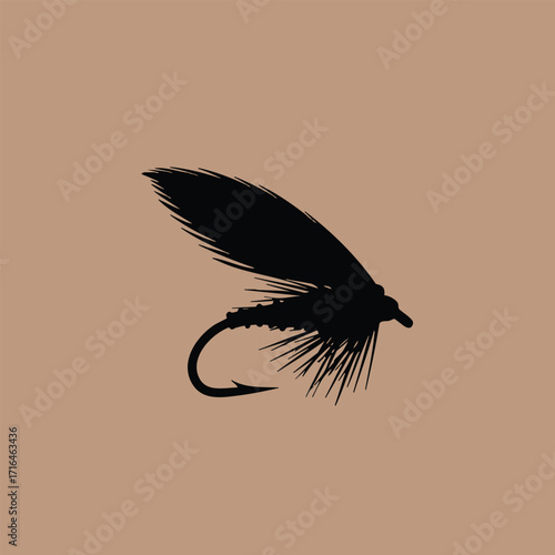 Silhouette of a detailed fishing fly lure with feather and hook on a plain brown background
