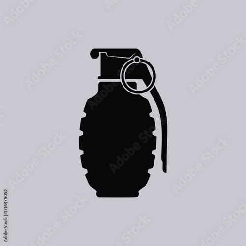 Black silhouette of a classic hand grenade with safety pin and lever on a plain gray background