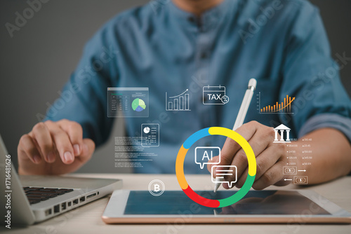 Fotografija finance analyst uses ai assistant on tablet with tax chart banking icons crypto and kpi dashboard at desk to automate bookkeeping forecast cash flow concept fintech productivity