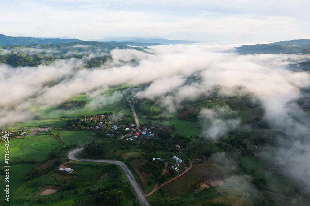Fototapeta premium Aerial view of rice terraces and village in Loei province, Thailand.