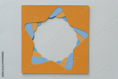 pile of stencils with star-shape cutouts in orange and blue on blank paper