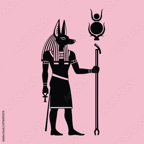Silhouette of an ancient Egyptian deity with a jackal head holding a staff and an ankh symbol on a pink background