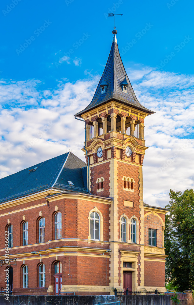 Naklejka premium Old post office in Spremberg Oberlausitz with architecture of red brick, tower and street view in the afternoon