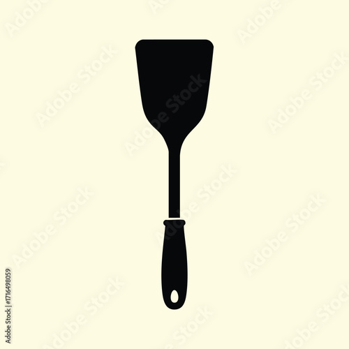 Black silhouette of a kitchen spatula with a handle isolated on a light background for cooking and baking use