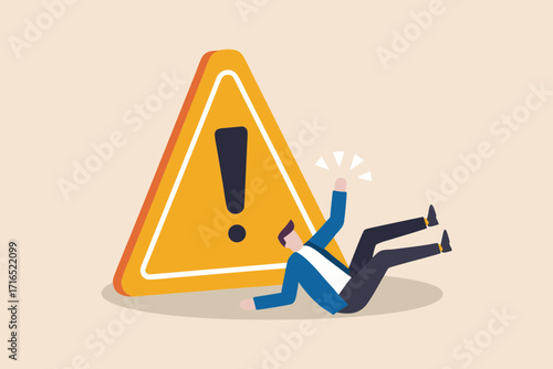 Businessman falling down near a large yellow warning sign with an exclamation mark indicating danger or risk