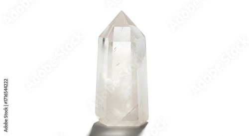 A clear, faceted quartz crystal point is shown standing upright against a white background, casting a subtle shadow.