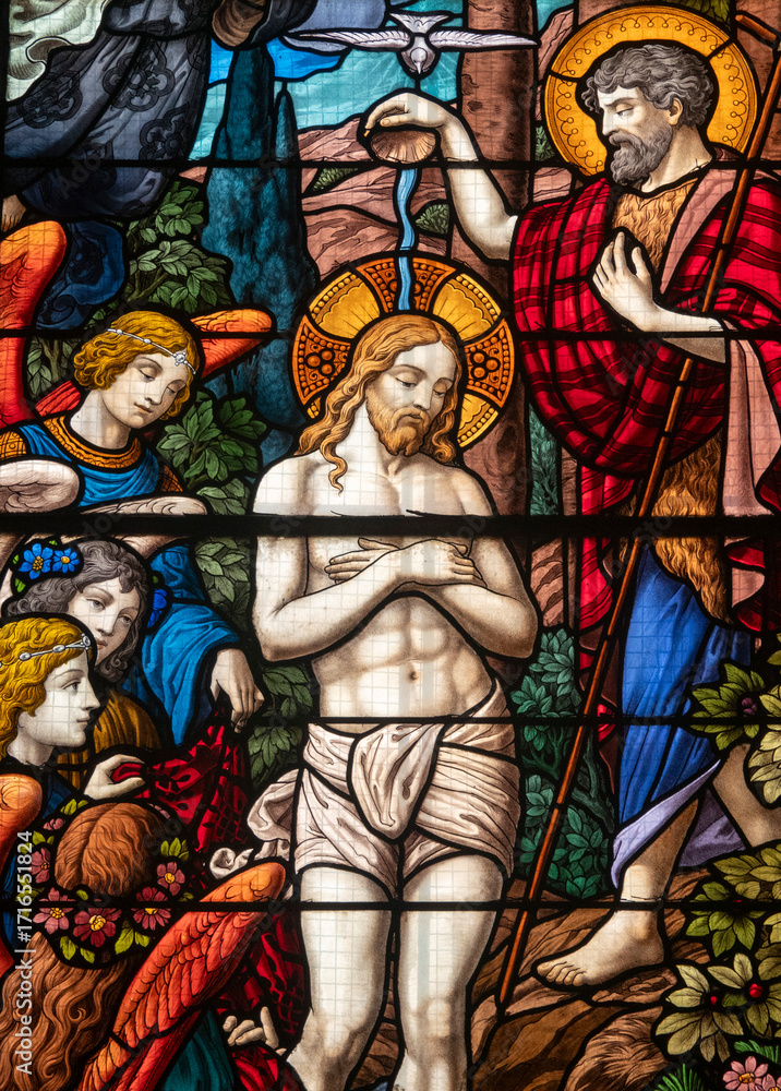 Obraz premium Stained glass (1934) of Baptism of Jesus by John the Baptist in the Jordan river.