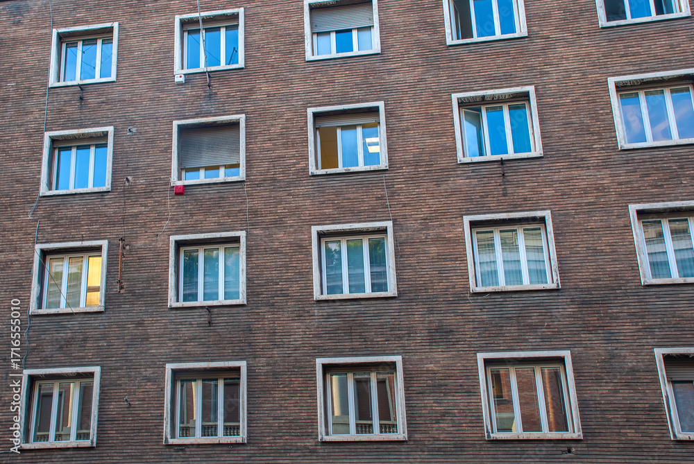 Fototapeta premium Brick Facade with Patterned Windows in Rome, Italy