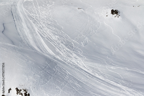 Snow off-piste slope with traces of skis and snowboards