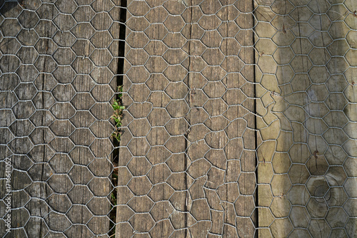 Close-up of wire mesh on wooden planks, East Midlands Airport Trail, Nottinghamshire, England, outdoor texture