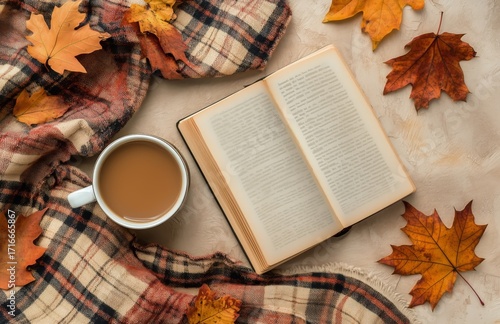 Cozy Autumn Scene With a Warm Drink and Open Book on Soft Fabric.