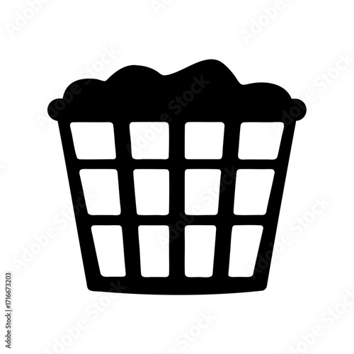 Black silhouette of laundry basket overflowing with clothes on white background