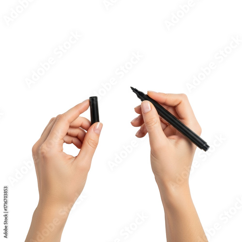 Young caucasian woman's hands holding a black chisel-tip marker hovering over a pristine transparent studio background with copy space, top-down view, concept of creative process genesis