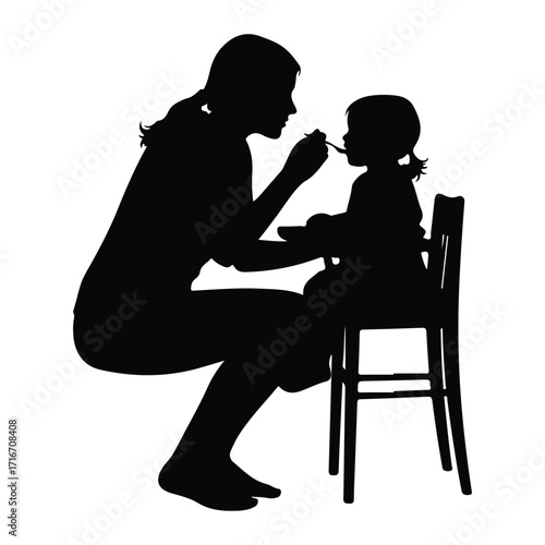 Mother feeding baby with spoon highchair